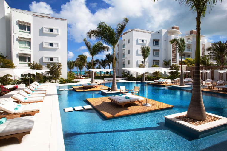 The pool at the Gansevoort Turks & Caicos where the beach chairs are set right in the water. 
